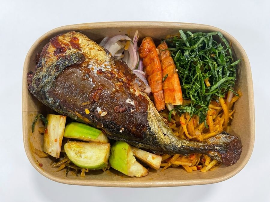 Abacha with Titus Fish, oporo, garden egg and utazi in a kraft takeaway box