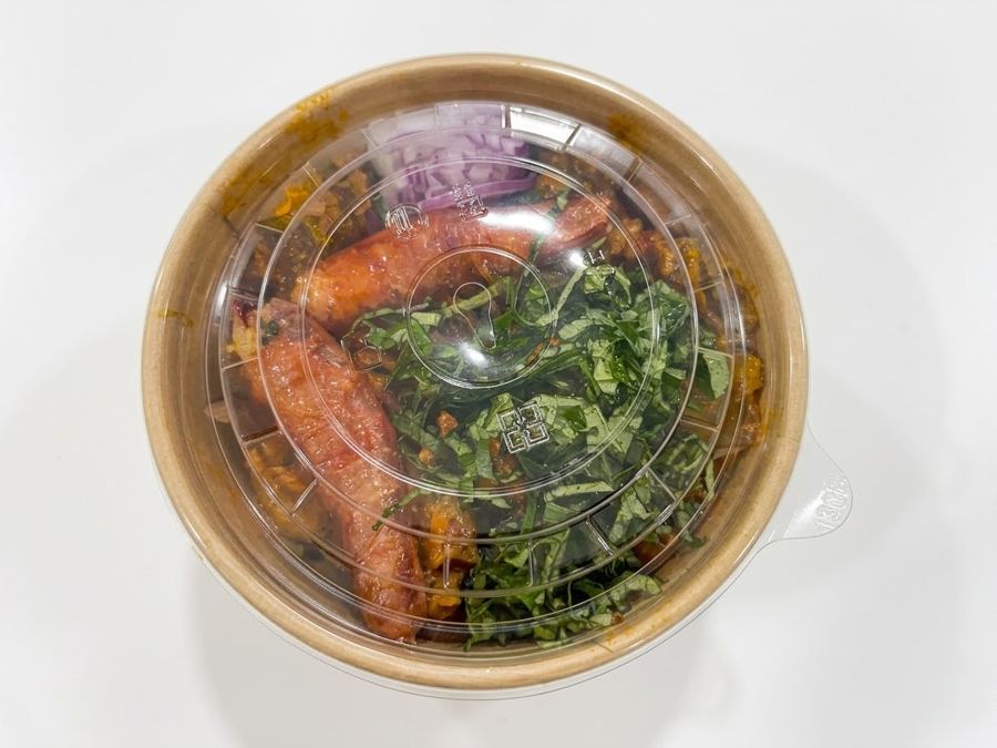 Nkwobi in a sealed kraft bowl with a clear lid